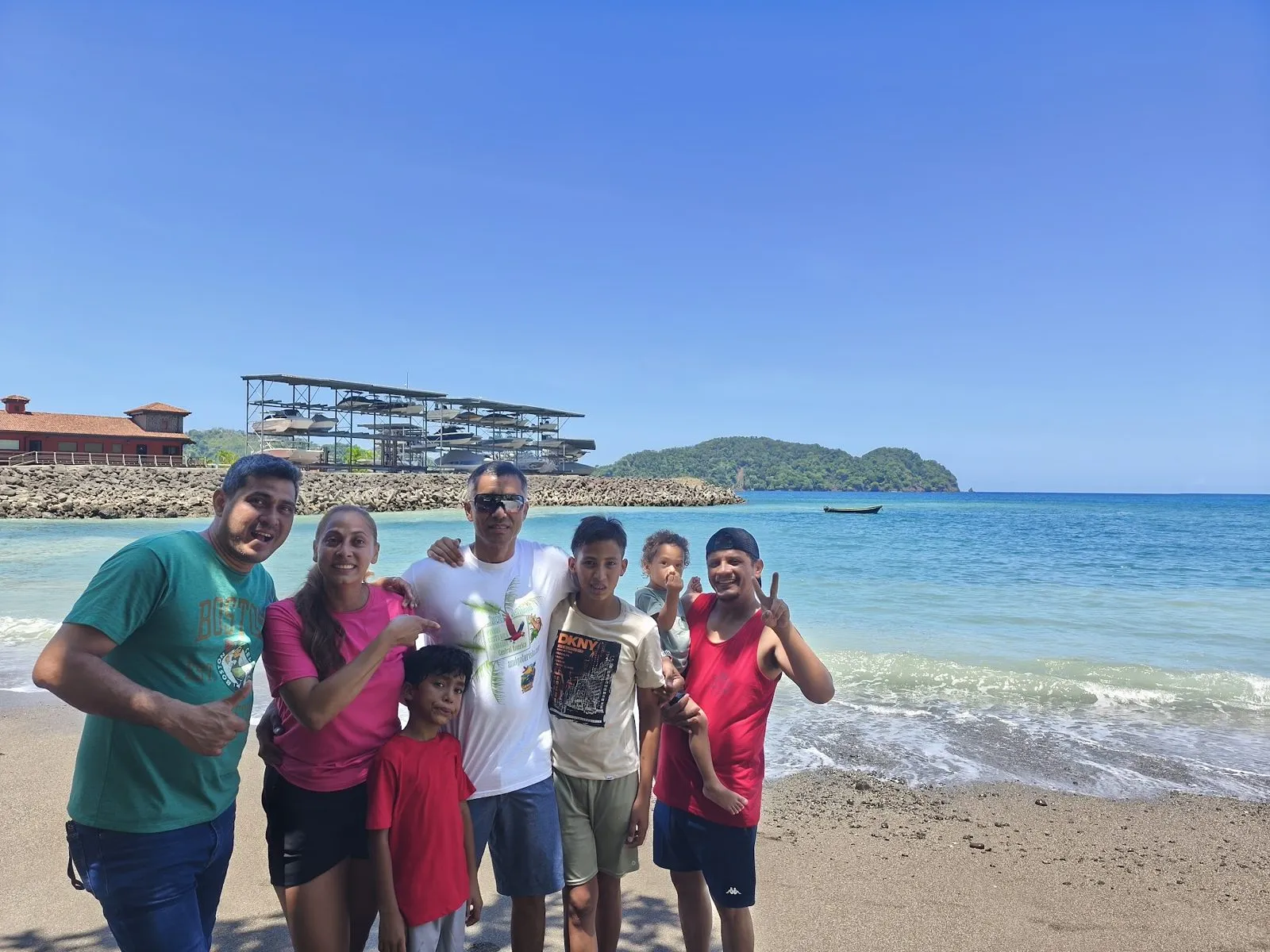 A family with kids on a beach with turquoise water