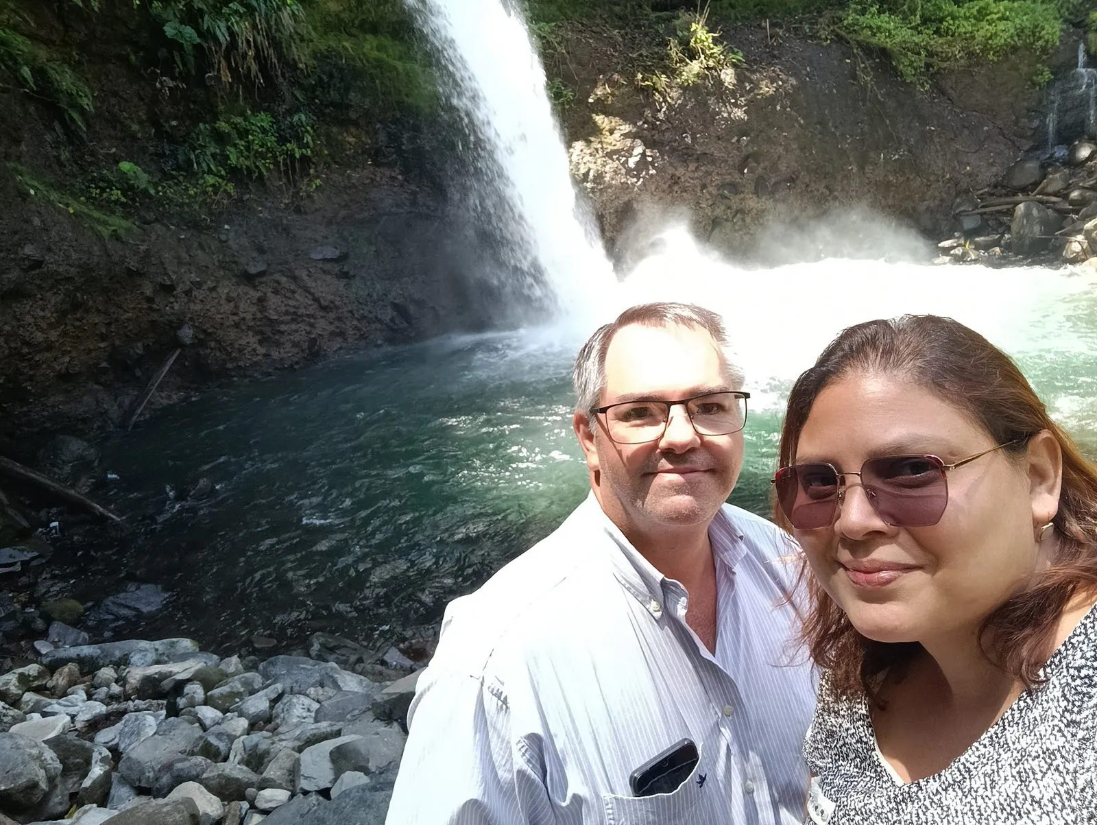 Gonzalo and a traveler taking a selfie at La Fortuna Waterfall
